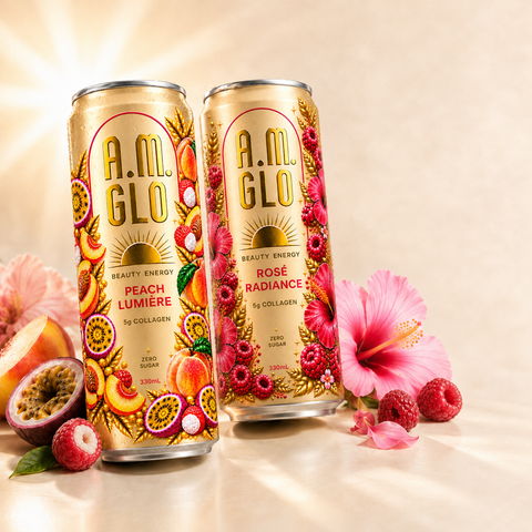 A.M. GLO Peach Lumiere and Rose Radiance cans standing together among raspberries, hibiscus and passionfruit